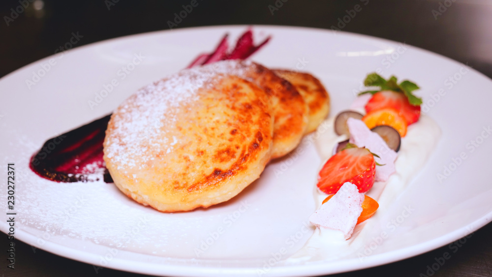 Homemade pancakes in a restaurant (at home) with jam and fruit are sprinkled with icing sugar. Concept from: Pancakes, Homemade, Restaurant, Fresh, Fruit, Jams, Icing Sugar, Strawberries, Cheesecakes. Homemade pancakes in a restaurant (at home) with jam and fruit are sprinkled with icing sugar. Concept from: Pancakes, Homemade, Restaurant, Fresh, Fruit, Jams, Icing Sugar, Strawberries, Cheesecakes.