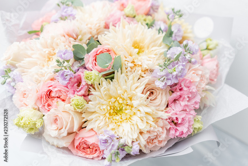 Fototapeta Naklejka Na Ścianę i Meble -  Beautiful spring bouquet in glass vase. Arrangement with various flowers. The concept of a flower shop. A set of photos for a site or catalogue. Work florist.