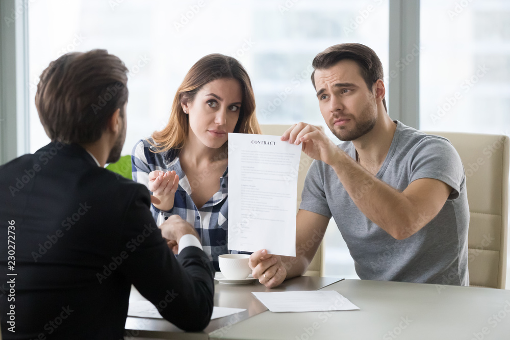 Φωτογραφία Young skeptic couple meet lawyer dissatisfied with terms of suspicious contract, refuse to sign
