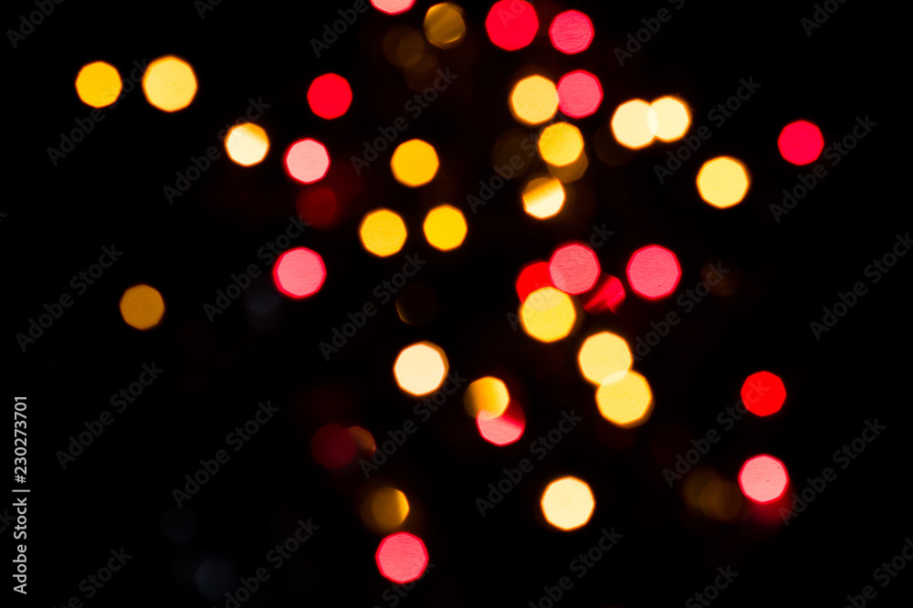 Obraz premium Red and yellow bokeh. Blurred lights background