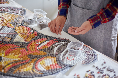 Bild auf Leinwand Crop artist composing mosaic