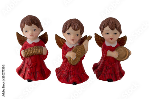 Christmas decoration. Three beautiful old Christmas angels made of ceramic which play different musical instruments isolated on a white background. Vintage and retro.