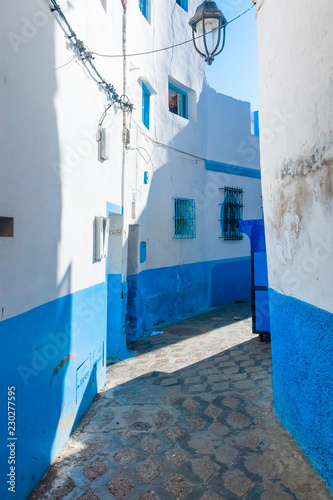 Beautiful blue street of white ancient medina of the Asilah village in Morocco © pszabo