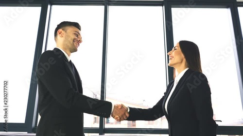 4K. Two business partner, man and woman, with pleasure shake hands when office  meeting. 
