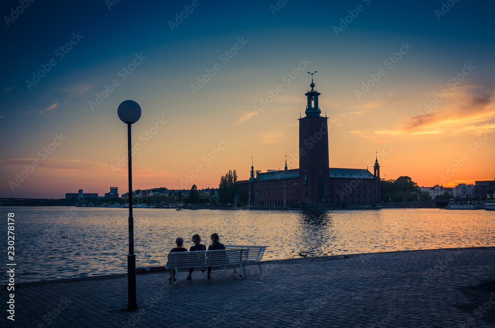 Silhouette of women sitting on bench, Stockholm City Hall, Sweden