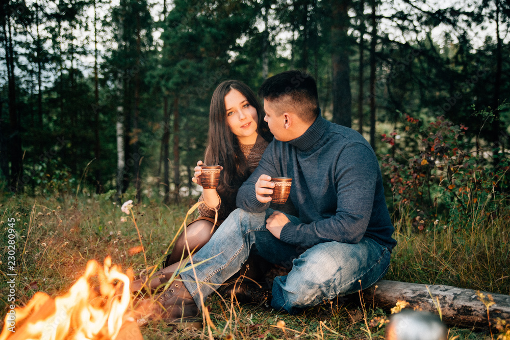 Summer Camp Fire. Tourism sexy photo. Cute couple kissing in the park on a sunny day. Adventure concept. Man and woman kissing. Couple in love. Camping fire. Love story. Romance lovers. Fashion photo. Summer Camp Fire. Tourism sexy photo. Cute couple kissing in the park on a sunny day. Adventure concept. Man and woman kissing. Couple in love. Camping fire. Love story. Romance lovers. Fashion photo.