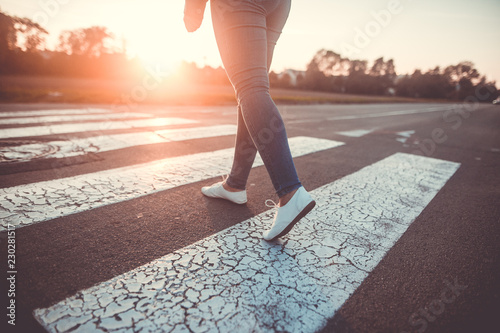 woman crossing the road at pedestrian crossing