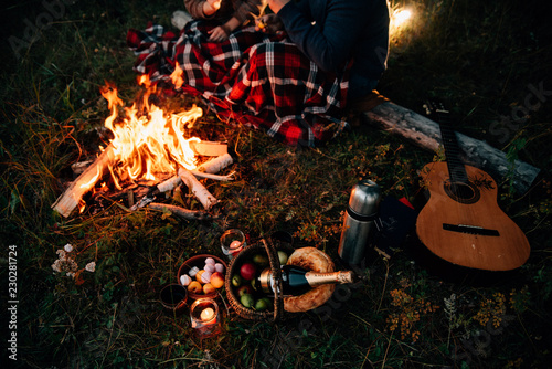 Summer Camp Fire. Tourism sexy photo. Cute couple kissing in the park on a sunny day. Adventure concept. Man and woman kissing. Couple in love. Camping fire. Love story. Romance lovers. Fashion photo.