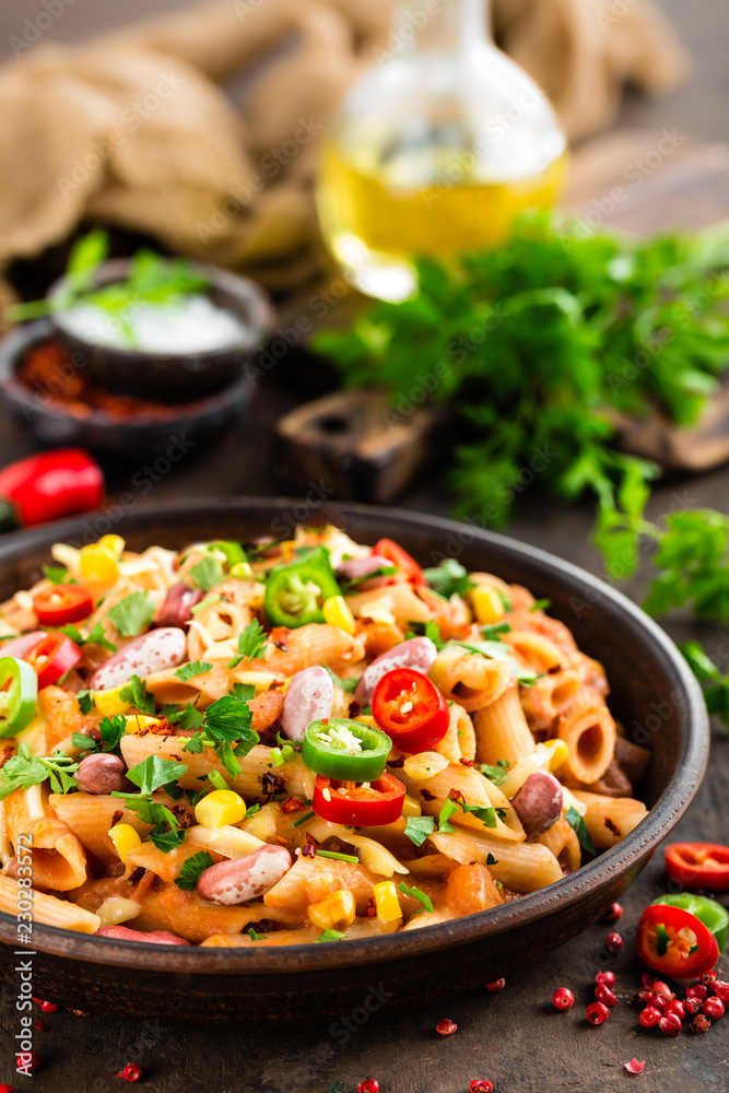 Spicy pasta penne bolognese with vegetables, beans, chili and cheese in tomato sauce Spicy pasta penne bolognese with vegetables, beans, chili and cheese in tomato sauce