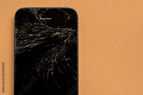 broken phone on a orange pastel background
