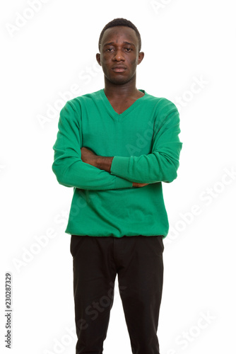 Young African man with arms crossed looking at camera