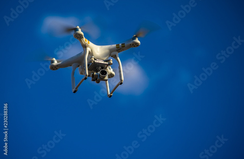 Fototapeta Naklejka Na Ścianę i Meble -  Flying the quadcopter on the background of blue sky.