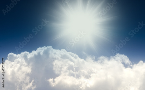 Cumulon cloud clouds, sun and blue sky 