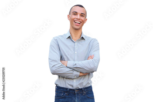 handsome young man smiling with arms crossed against isolated white background