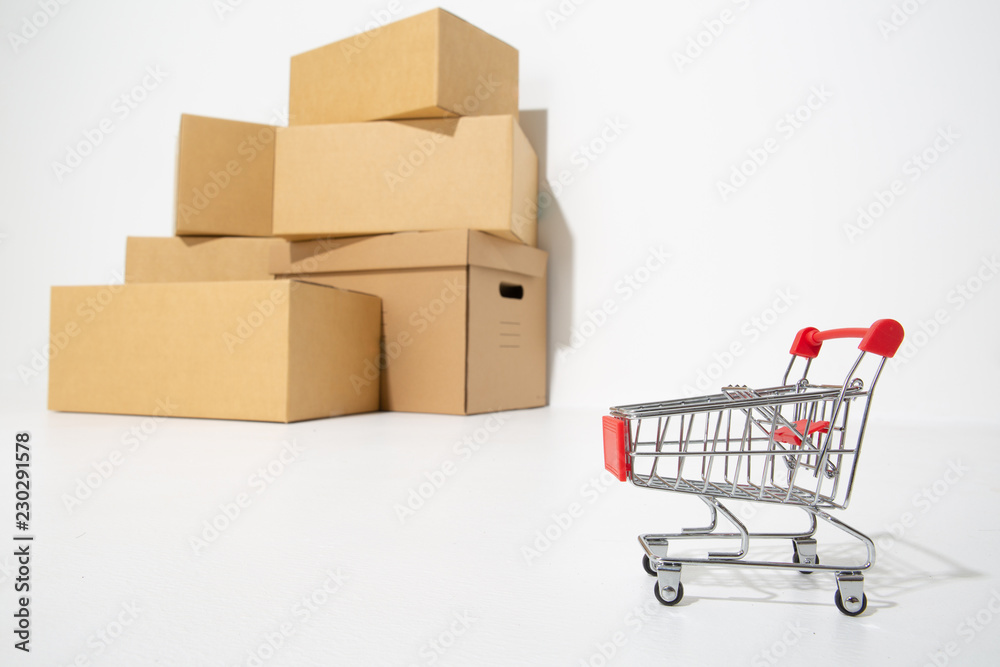 Brown different cardboard boxes arranged in stack and shopping cart .shopping concept