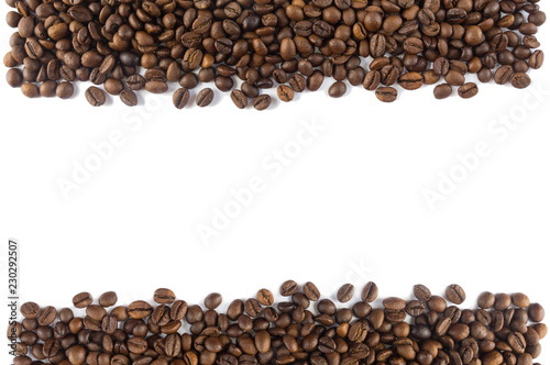 Coffee beans at border of image with copy space for text. Coffee background or texture concept. Coffee beans on white background. Top view.