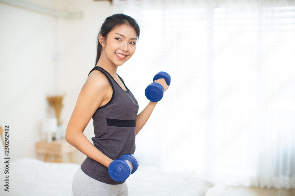 Sporty beautiful woman exercising at home to stay fit Sporty beautiful woman exercising at home to stay fit
