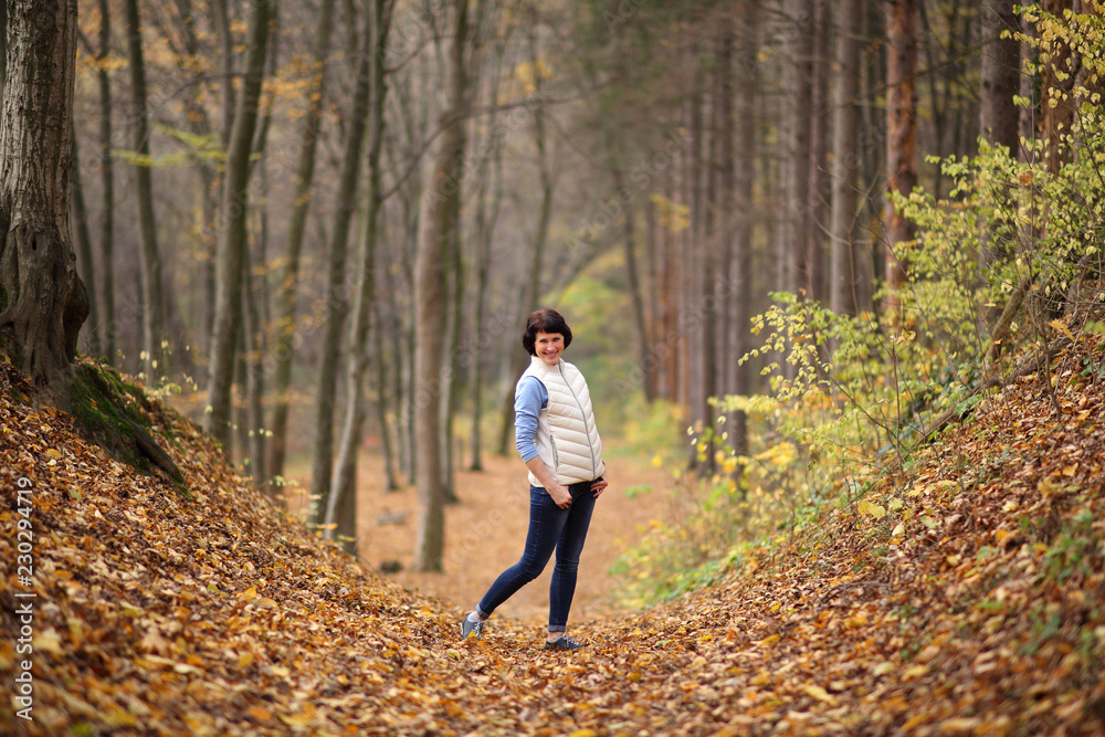 Girl in a yellow autumn forest. Beautiful young woman walks along the path of the autumn forest. Girl in a yellow autumn forest. Beautiful young woman walks along the path of the autumn forest.