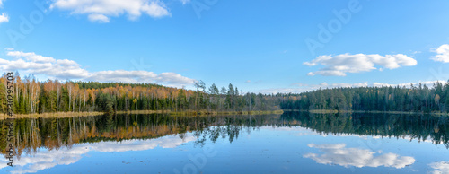 The lake Glubelka in the forest. Belarus. Autumn. The reflection of the clouds in the water