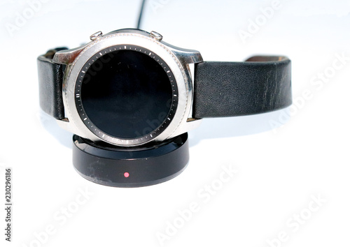 Smart-watch being recharged isolated on a white background photo