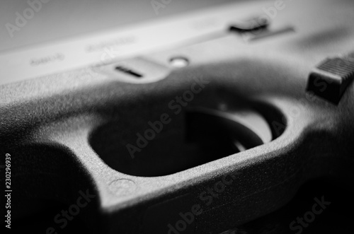 Valokuva Macro view of 9mm pistol trigger with shallow focal point