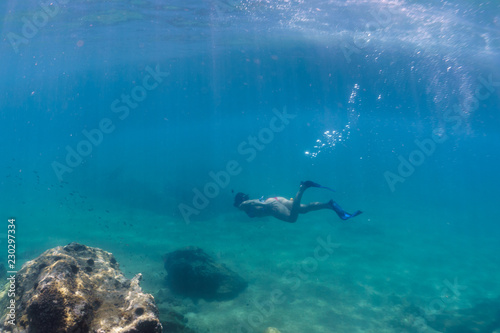 A girl with mask exploring underwater in the Mediterranean Sea