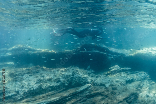 Man with spear gun diving on the breath hold in the underwater in the Mediterranean Sea