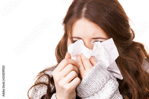 Tablou canvas Sick freezing woman sneezing in tissue