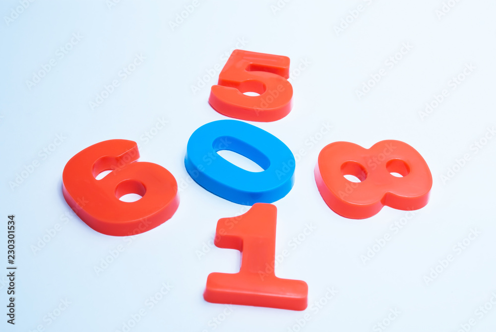 Multicolored numerals arranged chaotically on a white background Multicolored numerals arranged chaotically on a white background