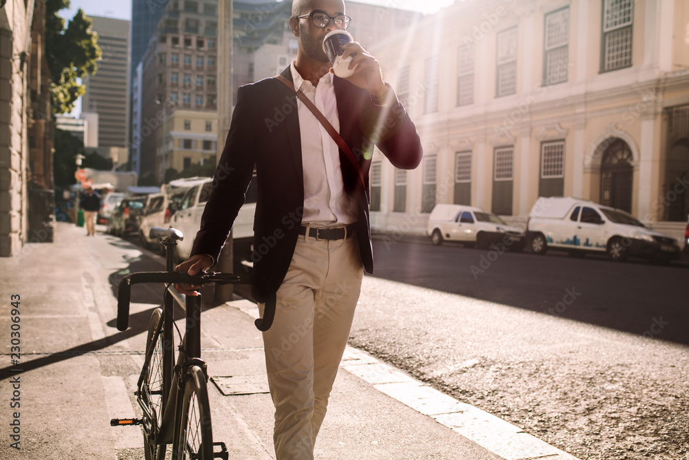 Fotografie Businessman going to work by bicycle