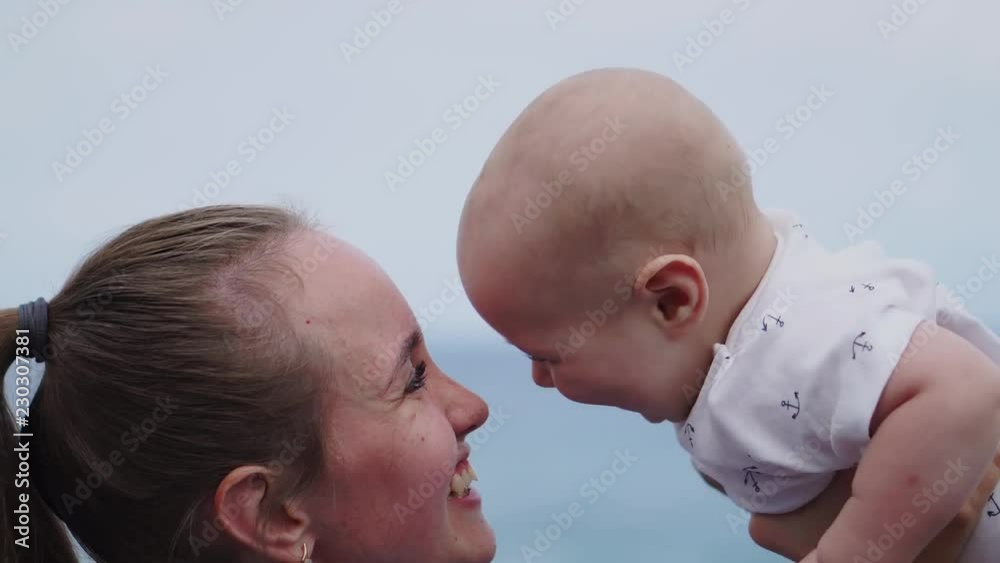 Family holiday on Tenerife, Spain, Europe. Mother and baby outdoors on ocean. Portrait travel tourists - mom with child. Positive human emotions, active lifestyles. Happy young family on sea beach Family holiday on Tenerife, Spain, Europe. Mother and baby outdoors on ocean. Portrait travel tourists - mom with child. Positive human emotions, active lifestyles. Happy young family on sea beach
