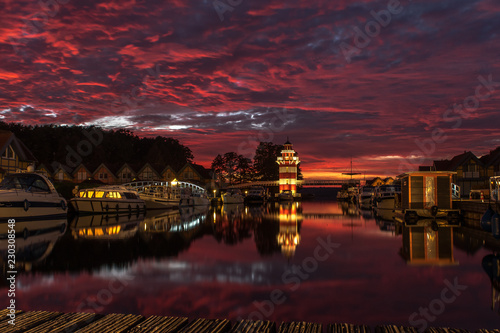 The Lighthouse in the Harbor Village Rheinsberg holiday resort in eastern Germany. In the background a spectacular sky. Concept: vacation and travel photo