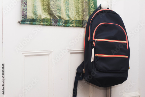 A backpack hanging on a door. Ready to go back to school.