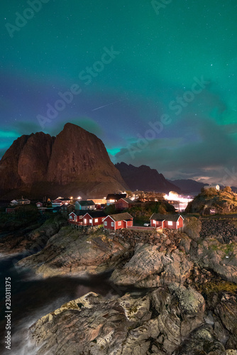 Northern Lights Aurora Borealis with classic view of the fisherman s village of Hamnoy, near Reine in Norway, Lofoten islands. This shot is powered by a wonderful Northern Lights show.