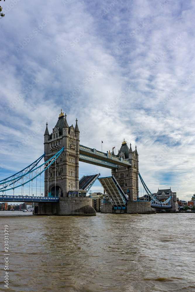 Tower Bridge on Thames river with the bridge open for ship traffic in London, UK
