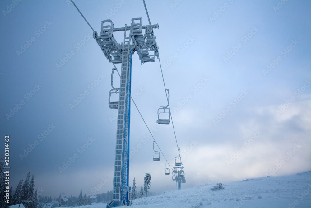 Frozen ski lift covered frost on gloomy day snowy mountains Frozen ski lift covered frost on gloomy day snowy mountains