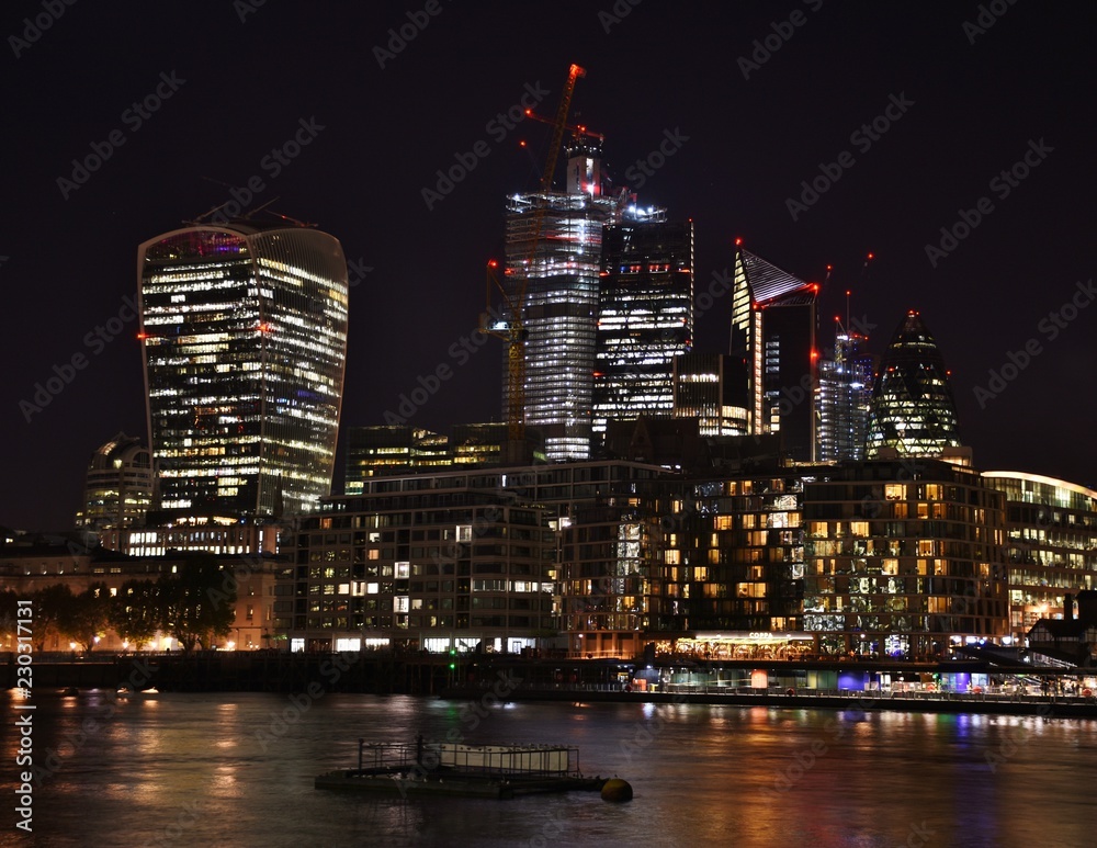 Downtown City of London along the North Bank of the Thames River at night.