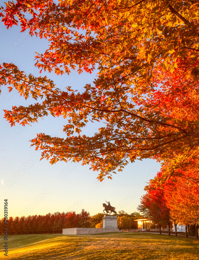 October 20, 2018 - St. Louis, Missouri - The sunrise and fall foliage around the Apotheosis of St. Louis statue of King Louis IX of France on Art Hill in Forest Park, St. Louis, Missouri.