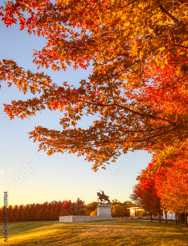 October 20, 2018 - St. Louis, Missouri - The sunrise and fall foliage around the Apotheosis of St. Louis statue of King Louis IX of France on Art Hill in Forest Park, St. Louis, Missouri.