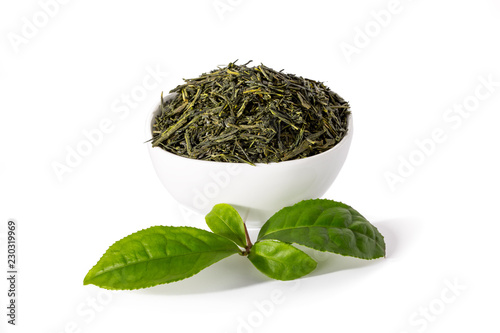 Green sencha tea in white cup with tealeaves photo