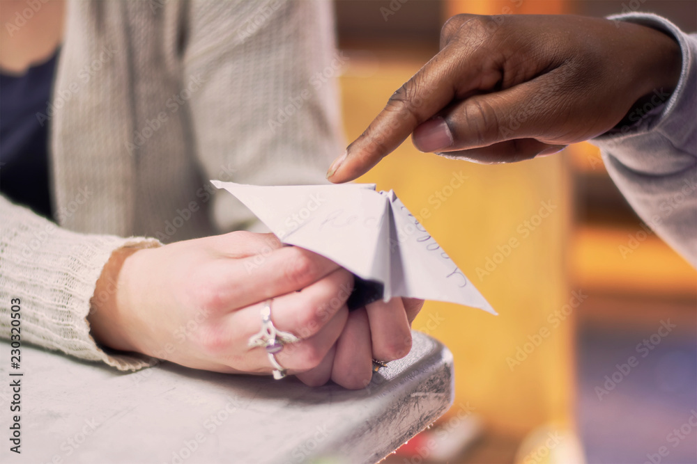 Two Kids play with a Cootie Catcher