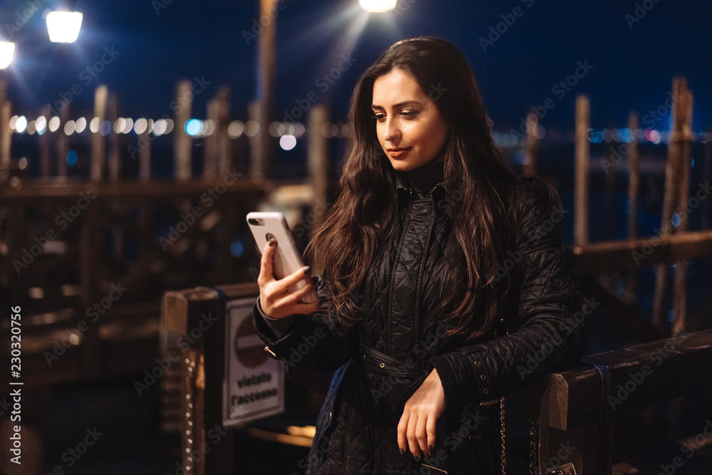 Beautiful young woman taking selfie in the city