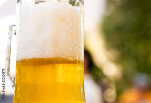 Close up glass mug of beer on the table in the outdoor luxury restaurant, Party fresh drink background with copy space