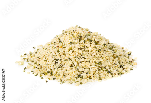 Heap of raw, organic hemp seeds over white