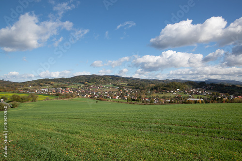 A view of the hill called Helf  t  n on the field and the surrounding can be seen village Krhov   during a sunny day