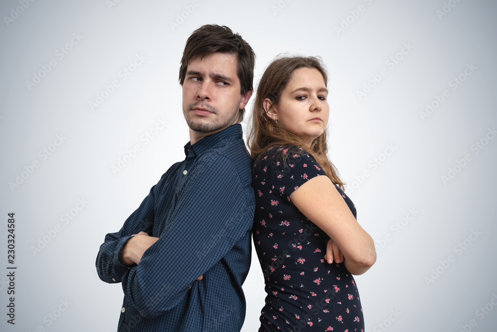 Young couple have problems. Upset man and woman standing back to back. Young couple have problems. Upset man and woman standing back to back.