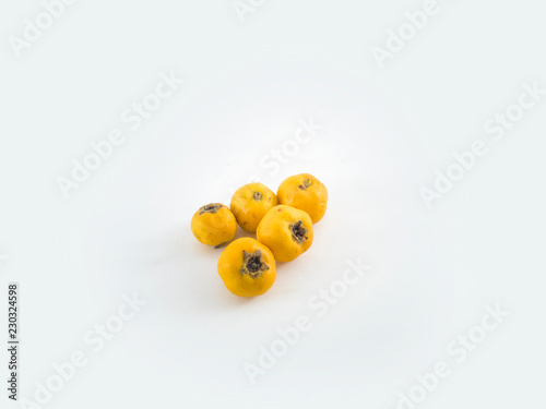 Yellow hawthorn berry with leaf isolated on white background close up path
