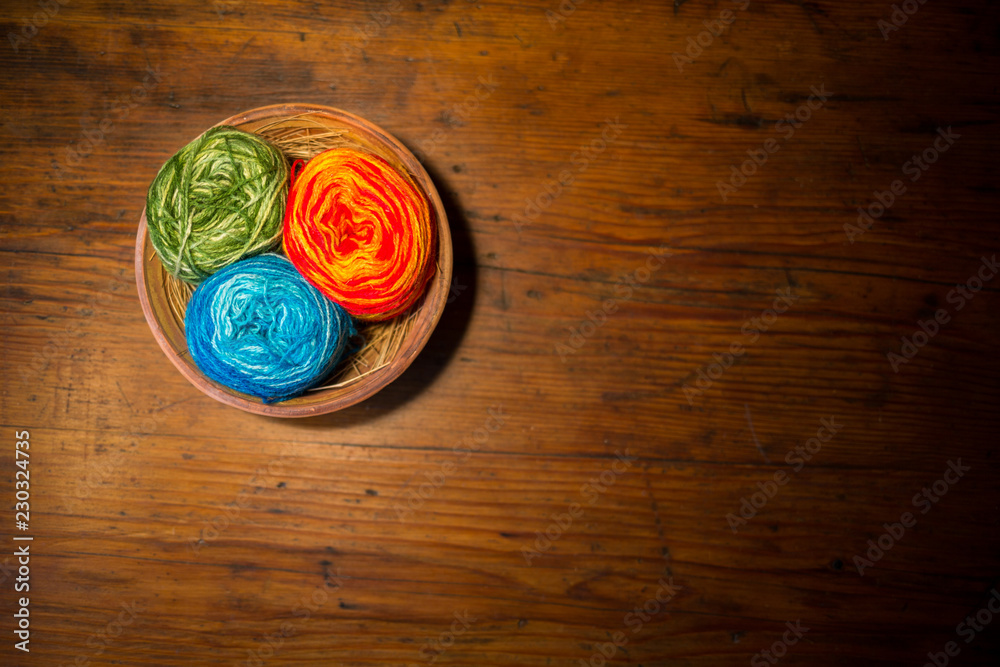 balls of wool on a country-style table balls of wool on a country-style table
