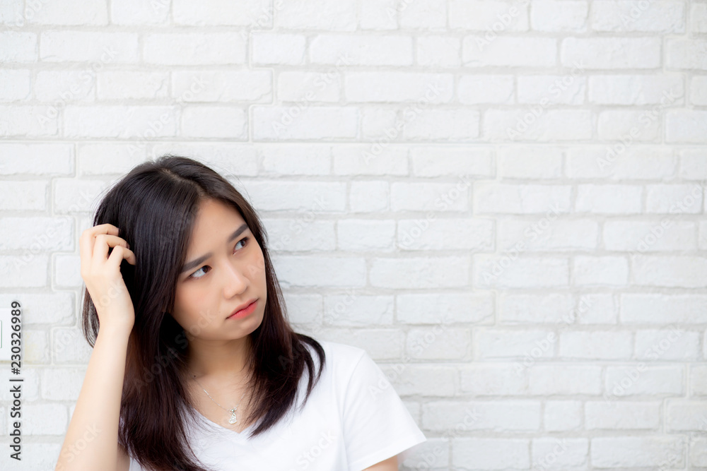 Beautiful portrait young asian woman confident thinking with cement and concrete brick background, girl standing expression serious or doubts with idea, lifestyle concept. Beautiful portrait young asian woman confident thinking with cement and concrete brick background, girl standing expression serious or doubts with idea, lifestyle concept.