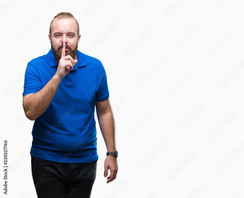 Young caucasian hipster man wearing blue shirt over isolated background asking to be quiet with finger on lips. Silence and secret concept. Young caucasian hipster man wearing blue shirt over isolated background asking to be quiet with finger on lips. Silence and secret concept.